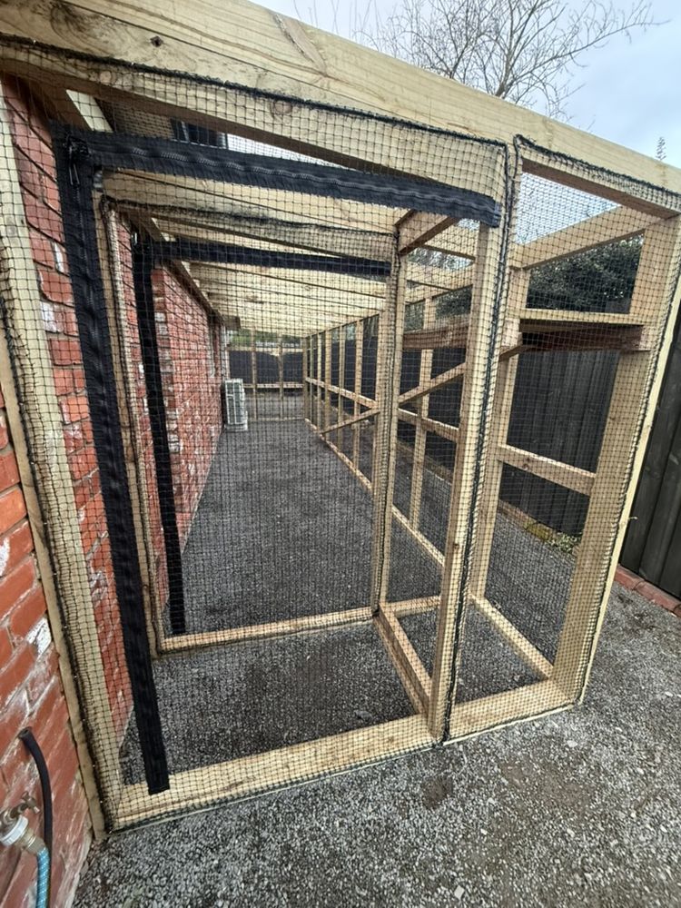 Long netted catio walkway built along a brick house