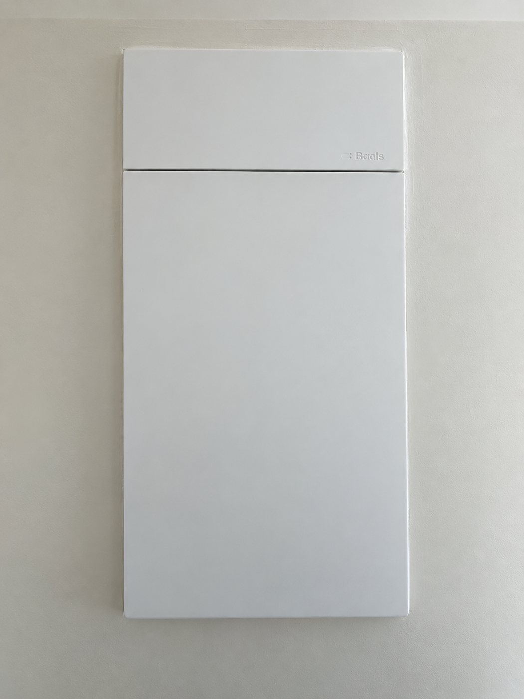 Finished switchboard with the cover closed, flush on a freshly finished wall